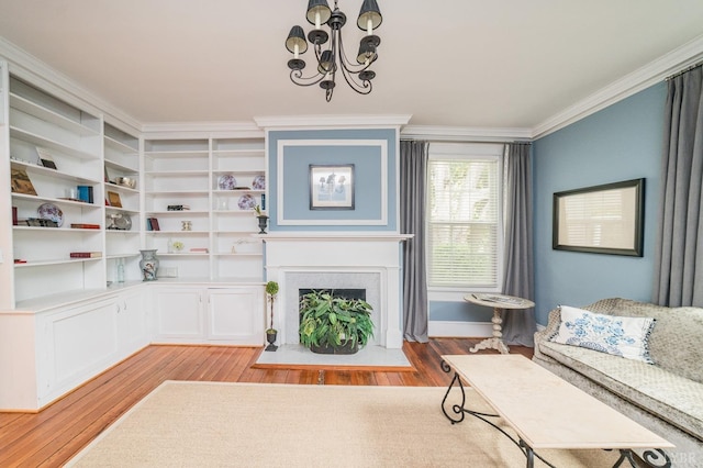 7821 Bellevue Rd, Forest, VA 24551 - living room with crown molding, light wood finished floors, a chandelier, and a fireplace