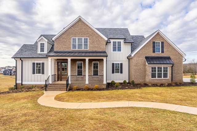 view of front of home with a front yard and a porch