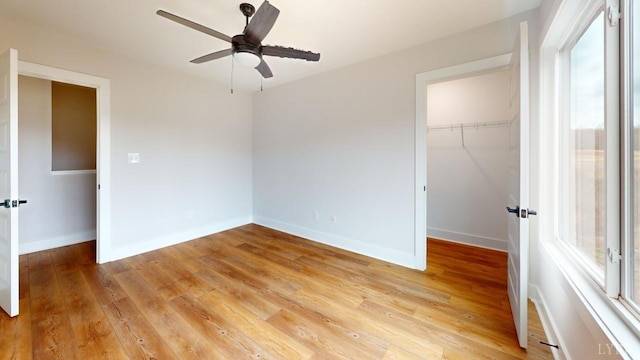 165 Allure Dr, Rustburg, VA 24588 - unfurnished bedroom with a closet, wood finished floors, a walk in closet, and baseboards
