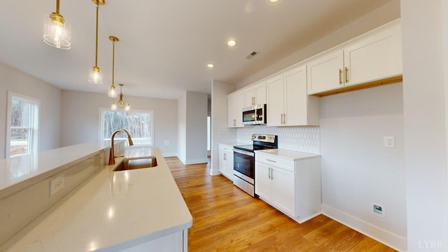 165 Allure Dr, Rustburg, VA 24588 - kitchen with stainless steel appliances, pendant lighting, light countertops, and a sink
