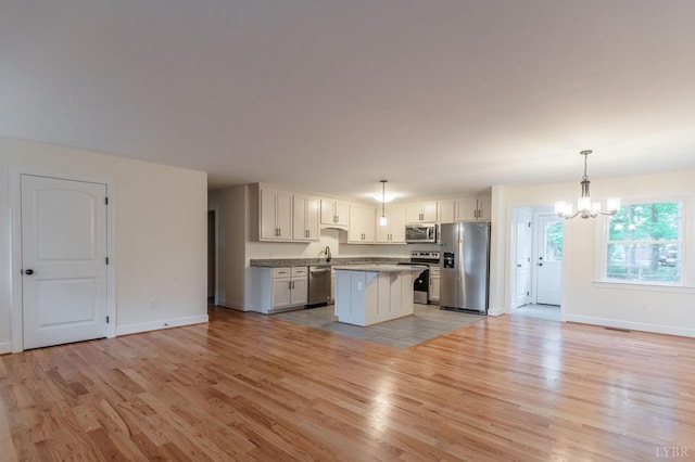 465 Soybean Dr, Appomattox, VA 24522 - kitchen with appliances with stainless steel finishes, a chandelier, open floor plan, and light wood finished floors
