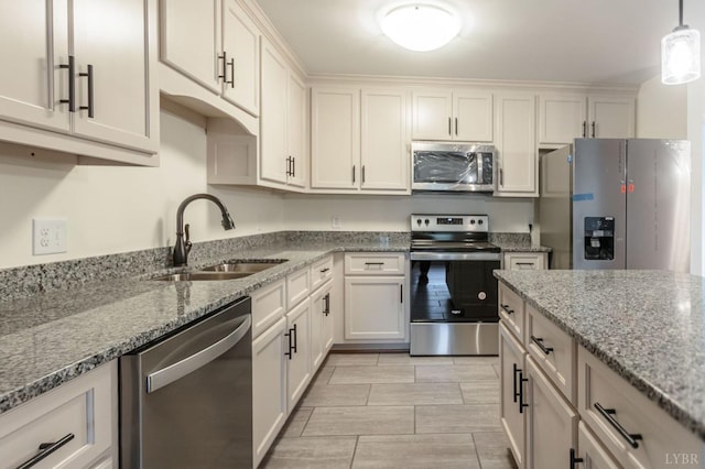 465 Soybean Dr, Appomattox, VA 24522 - kitchen with stainless steel appliances, a sink, light stone counters, decorative light fixtures, and white cabinets