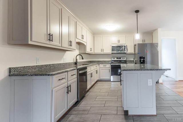 465 Soybean Dr, Appomattox, VA 24522 - kitchen with appliances with stainless steel finishes, a sink, a center island, wood tiled floors, and dark stone counters