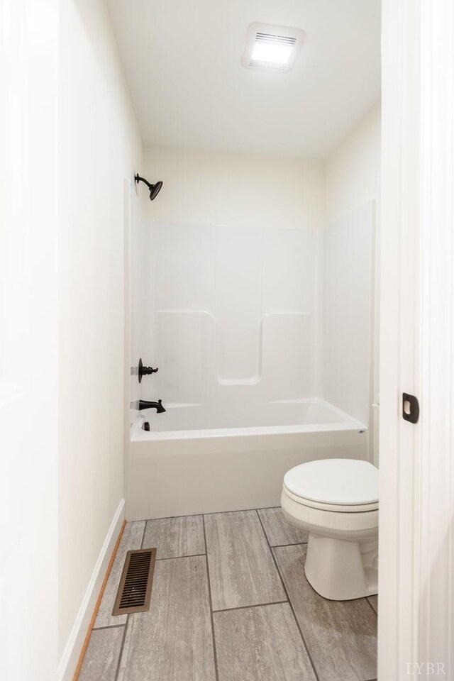 465 Soybean Dr, Appomattox, VA 24522 - bathroom featuring toilet, washtub / shower combination, wood finished floors, and baseboards