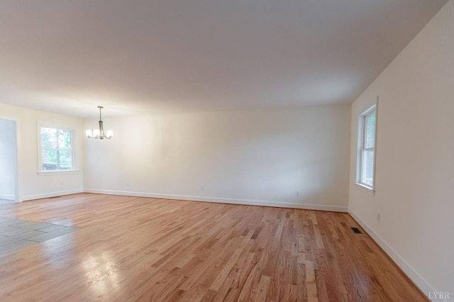 465 Soybean Dr, Appomattox, VA 24522 - unfurnished room with a chandelier, light wood-style flooring, and baseboards