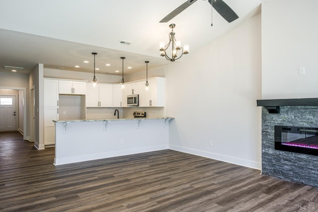 104 Lockridge Ln, Lynchburg, VA 24502 - kitchen with stainless steel appliances, recessed lighting, white cabinets, light stone counters, and dark wood-style floors