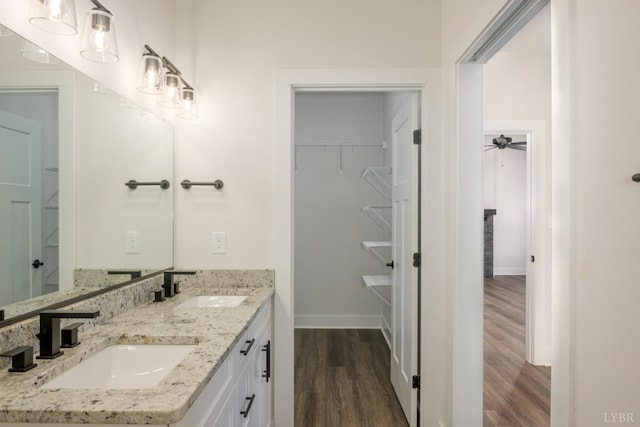 104 Lockridge Ln, Lynchburg, VA 24502 - bathroom featuring wood finished floors, baseboards, a spacious closet, double vanity, and a ceiling fan