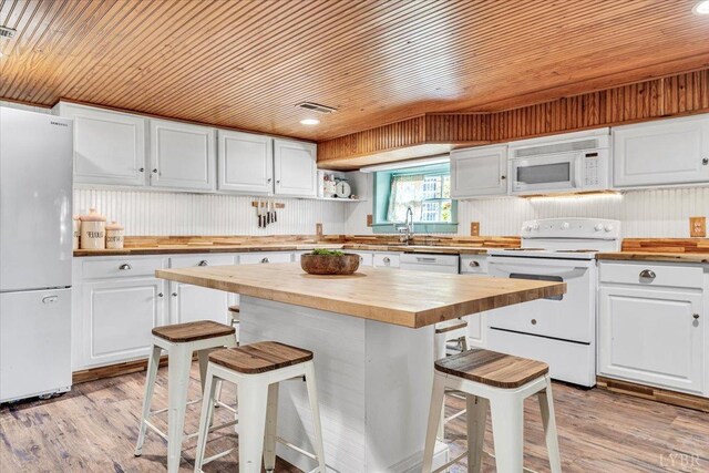 2816 Lowesville Rd, Lowesville, VA 22922 - kitchen featuring wood counters, white appliances, wooden ceiling, a kitchen breakfast bar, and white cabinetry