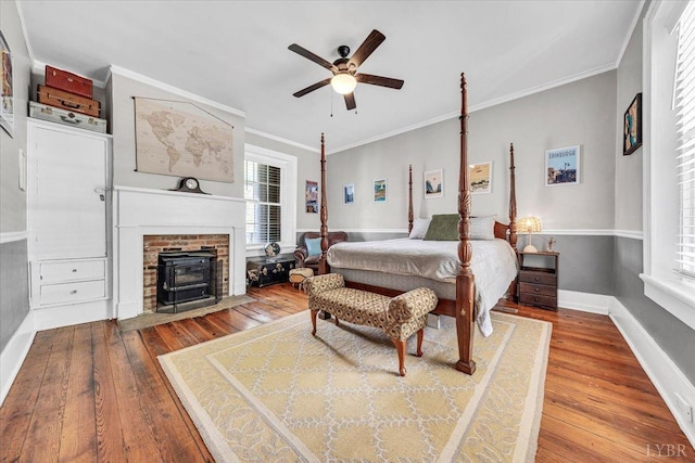 2816 Lowesville Rd, Lowesville, VA 22922 - bedroom featuring a wood stove, wood-type flooring, multiple windows, baseboards, and ornamental molding