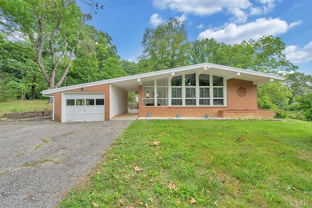 ranch-style home with a garage and a front lawn