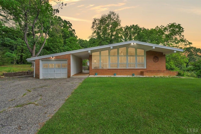 single story home featuring a yard and a garage