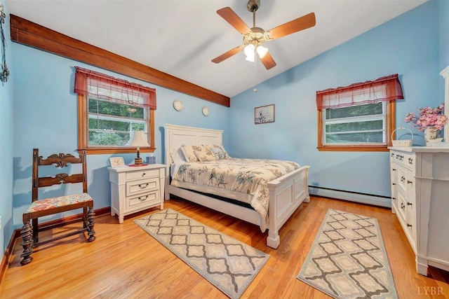 bedroom featuring light hardwood / wood-style flooring, a baseboard radiator, vaulted ceiling, and ceiling fan