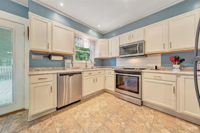 kitchen featuring light tile patterned flooring, sink, stainless steel appliances, and ornamental molding