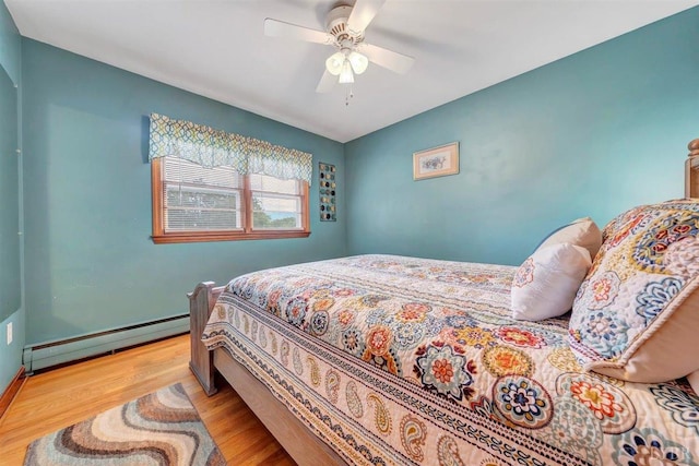 bedroom featuring light hardwood / wood-style flooring, a baseboard radiator, and ceiling fan