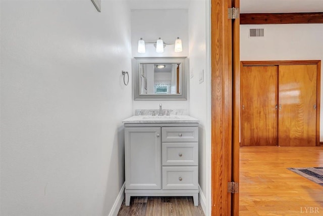 bathroom featuring vanity and hardwood / wood-style flooring