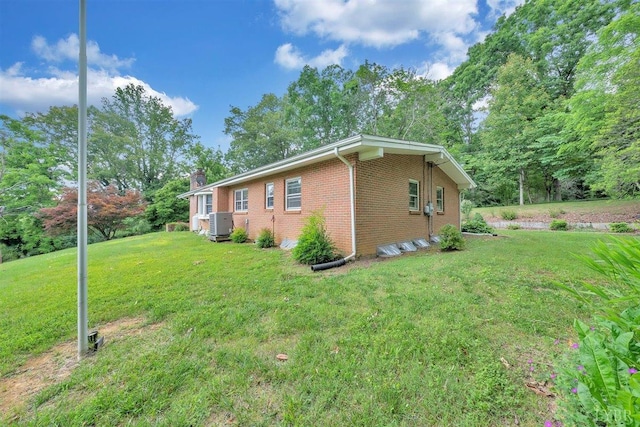 view of side of home featuring a lawn