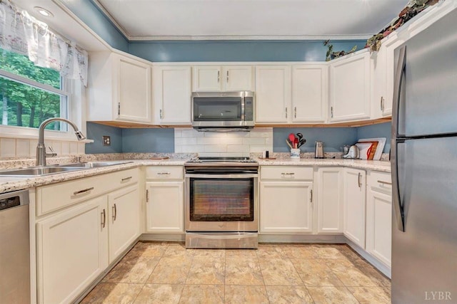 kitchen featuring tasteful backsplash, stainless steel appliances, light stone countertops, light tile patterned floors, and sink