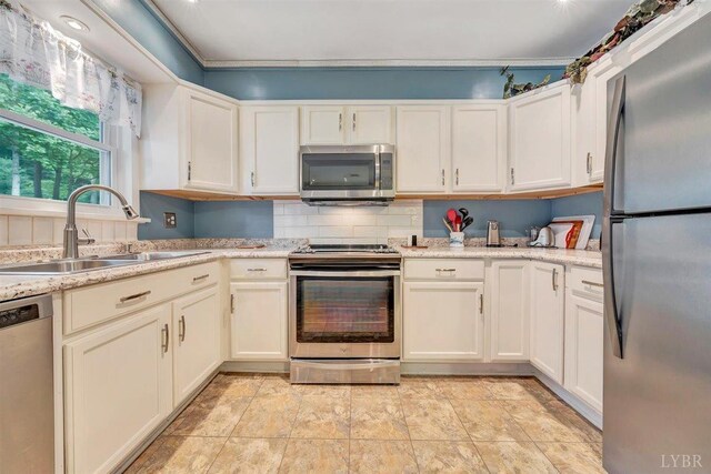 kitchen with decorative backsplash, light tile patterned flooring, stainless steel appliances, light stone countertops, and sink