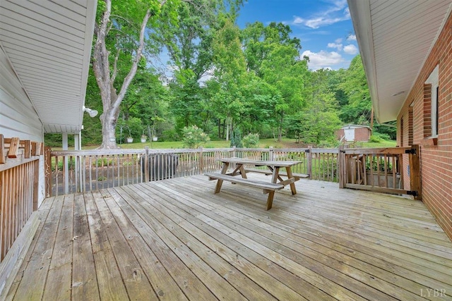 wooden deck featuring a storage unit