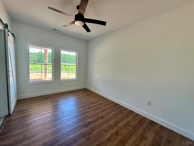 4678 Wildway Rd, Appomattox, VA 24522 - spare room with a barn door, baseboards, and dark wood-style flooring