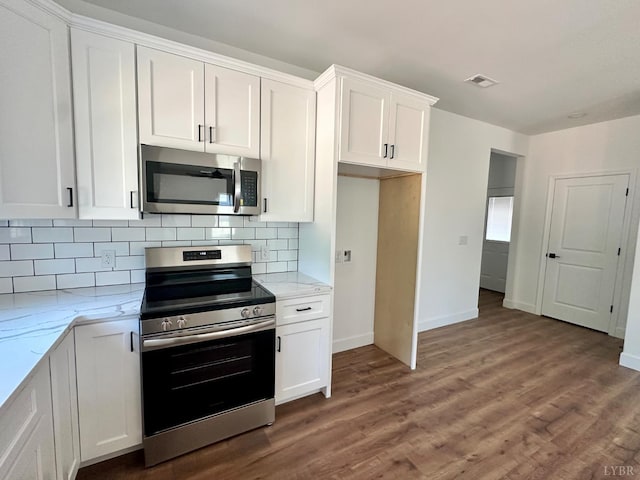 4678 Wildway Rd, Appomattox, VA 24522 - kitchen featuring appliances with stainless steel finishes, light stone counters, white cabinets, and backsplash
