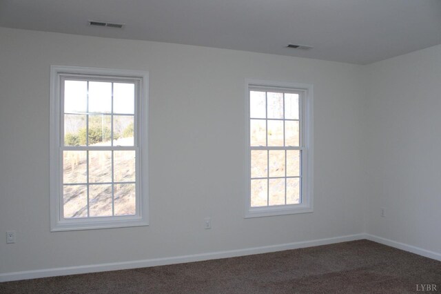 872 Two Bid Rd, Evington, VA 24550 - empty room featuring visible vents, dark colored carpet, and a healthy amount of sunlight
