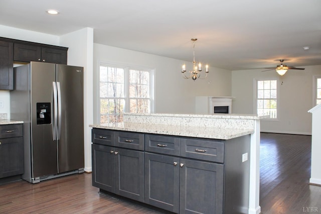 872 Two Bid Rd, Evington, VA 24550 - kitchen featuring open floor plan, stainless steel fridge with ice dispenser, ceiling fan with notable chandelier, dark wood finished floors, and a fireplace
