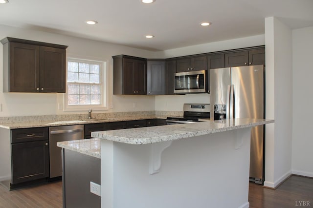 872 Two Bid Rd, Evington, VA 24550 - kitchen featuring dark wood-style floors, dark brown cabinets, appliances with stainless steel finishes, and recessed lighting