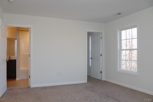 872 Two Bid Rd, Evington, VA 24550 - unfurnished bedroom featuring light colored carpet, visible vents, multiple windows, and baseboards