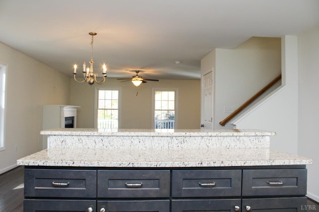 872 Two Bid Rd, Evington, VA 24550 - kitchen featuring open floor plan, ceiling fan with notable chandelier, light stone counters, and dark wood-type flooring