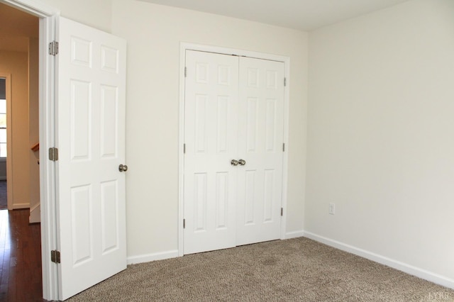 872 Two Bid Rd, Evington, VA 24550 - unfurnished bedroom featuring baseboards, a closet, and dark colored carpet