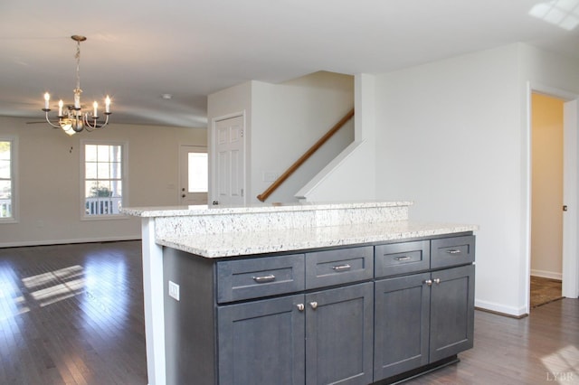872 Two Bid Rd, Evington, VA 24550 - kitchen with baseboards, dark wood-style flooring, gray cabinetry, and a notable chandelier