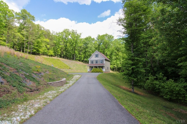 872 Two Bid Rd, Evington, VA 24550 - view of front of house featuring a wooded view, aphalt driveway, a garage, and a front lawn