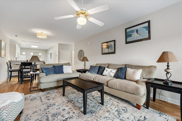 1055 Mariners Way, Huddleston, VA 24104 - living area with wood finished floors, baseboards, and ceiling fan