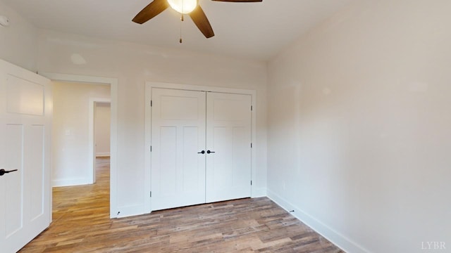 87 Greenhouse Rd, Rustburg, VA 24588 - unfurnished bedroom featuring baseboards, a ceiling fan, a closet, and wood finished floors