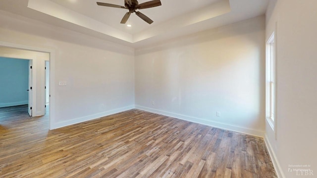 87 Greenhouse Rd, Rustburg, VA 24588 - empty room featuring ceiling fan, recessed lighting, baseboards, wood finished floors, and a tray ceiling