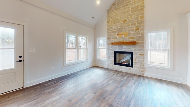 87 Greenhouse Rd, Rustburg, VA 24588 - unfurnished living room with a healthy amount of sunlight, baseboards, a stone fireplace, and wood finished floors