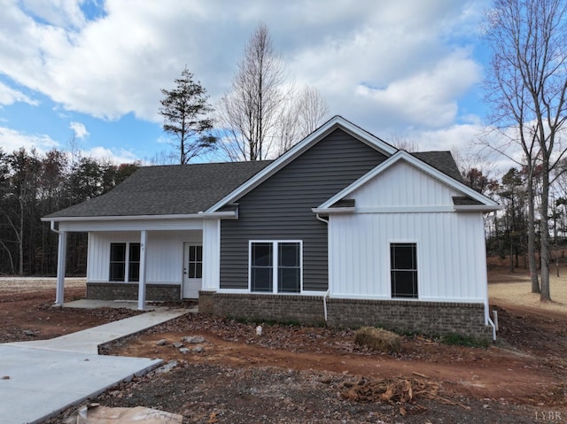 87 Greenhouse Rd, Rustburg, VA 24588 - view of front of property featuring brick siding, board and batten siding, roof with shingles, and a porch