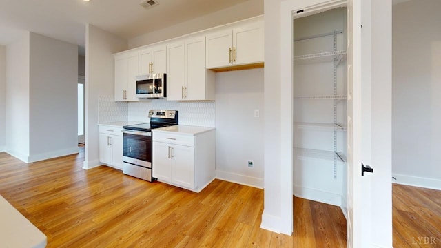 193 Allure Dr, Rustburg, VA 24588 - kitchen with white cabinets, decorative backsplash, stainless steel appliances, light countertops, and light wood-type flooring
