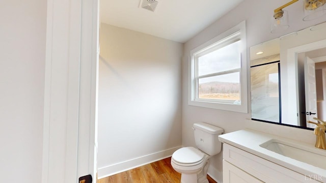 193 Allure Dr, Rustburg, VA 24588 - bathroom featuring visible vents, toilet, vanity, wood finished floors, and baseboards