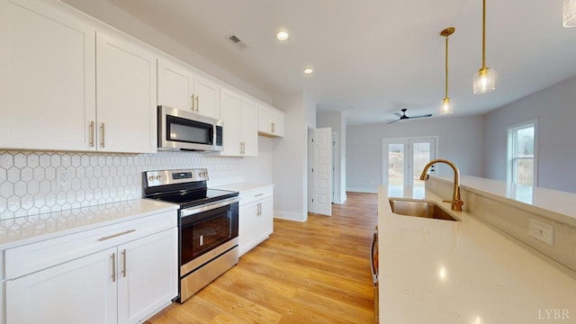 193 Allure Dr, Rustburg, VA 24588 - kitchen with a sink, stainless steel appliances, light countertops, and decorative light fixtures