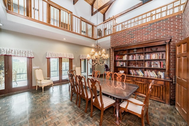 dining room with high vaulted ceiling, beamed ceiling, an inviting chandelier, parquet flooring, and french doors