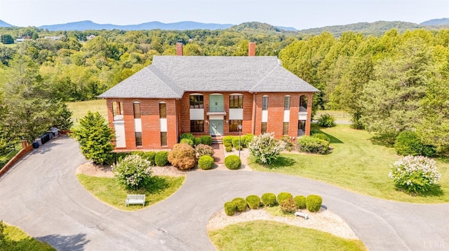 exterior space with a wooded view and a mountain view