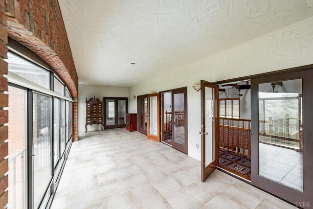 unfurnished sunroom with french doors