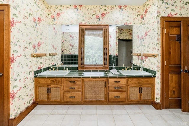 full bath featuring wallpapered walls, tile patterned flooring, and a sink
