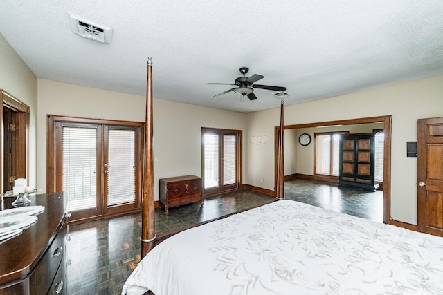 bedroom with access to exterior, visible vents, french doors, and a textured ceiling
