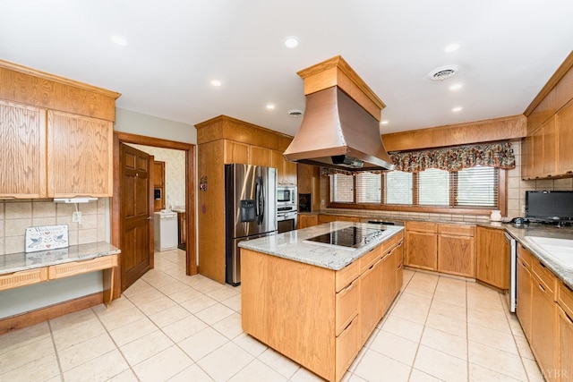 kitchen featuring visible vents, stainless steel appliances, a kitchen island, tasteful backsplash, and island range hood