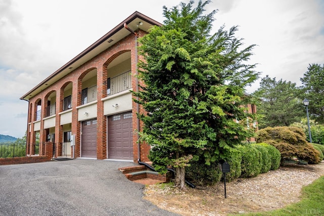 exterior space with a garage and aphalt driveway