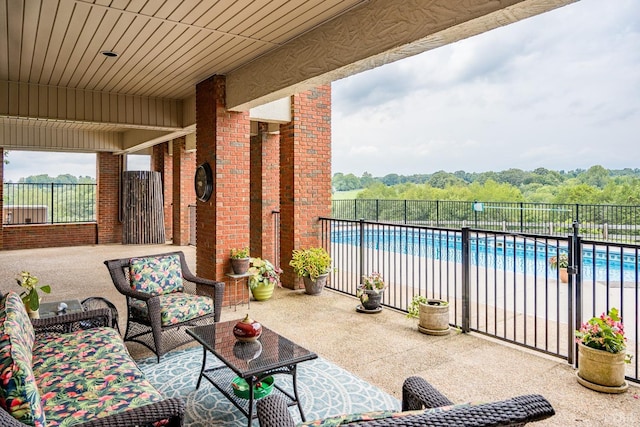 view of patio with fence and a fenced in pool