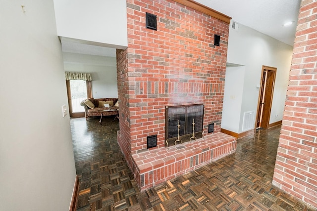 living room featuring baseboards, a fireplace, and visible vents